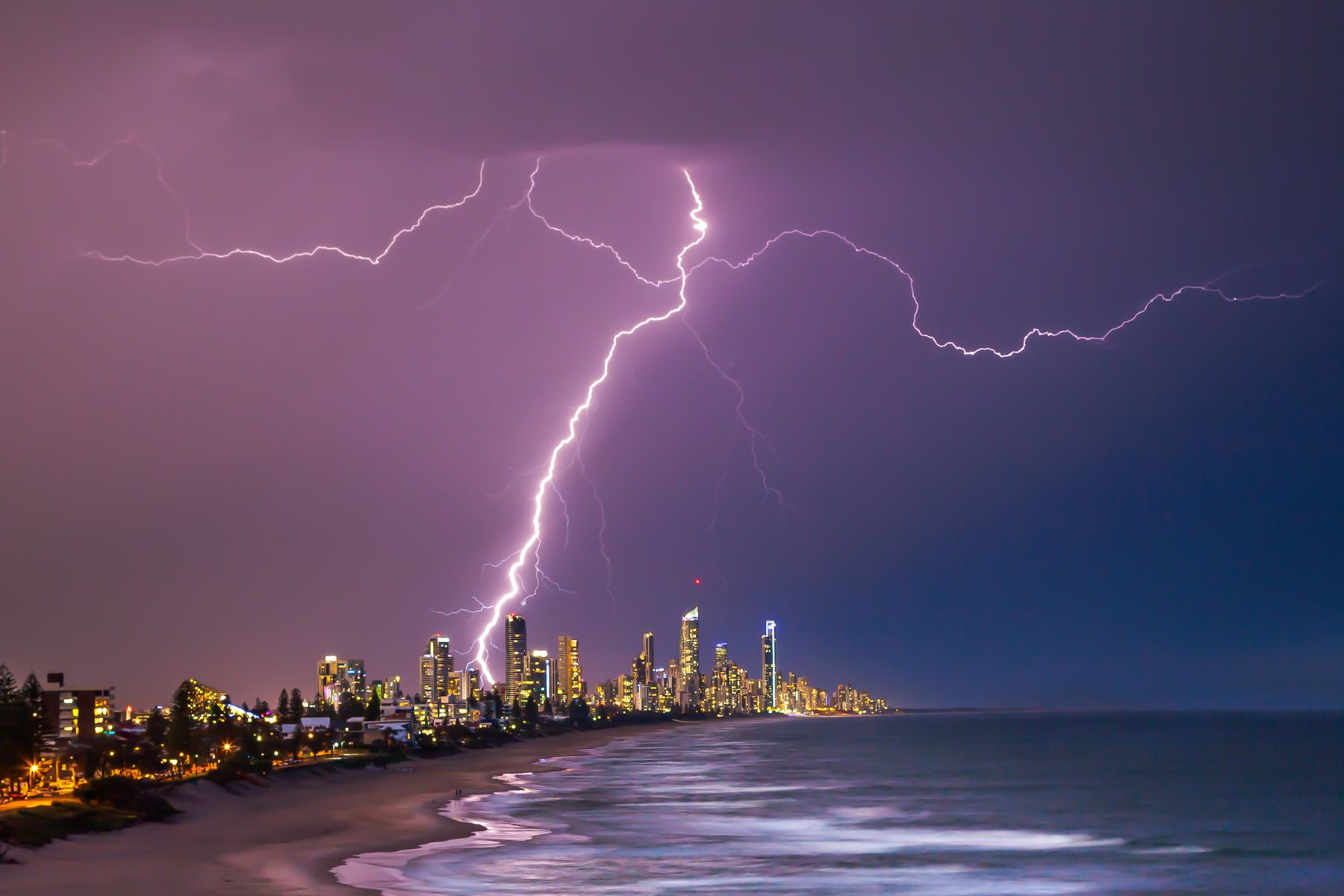 Lightning strike over the Surfers Paradise skyline at night, seen from the beach